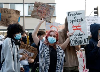 Protesters hold signs as they demonstrate outside of a Turning Point USA event at the University of California, Berkeley, on Nov. 10, 2025, in Berkeley, California.