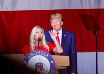 President Donald Trump looks on as Rep. Marjorie Taylor Greene speaks during his remarks at the Georgia state Republican convention at the Columbus Convention and Trade Center on June 10, 2023, in Columbus, Georgia.