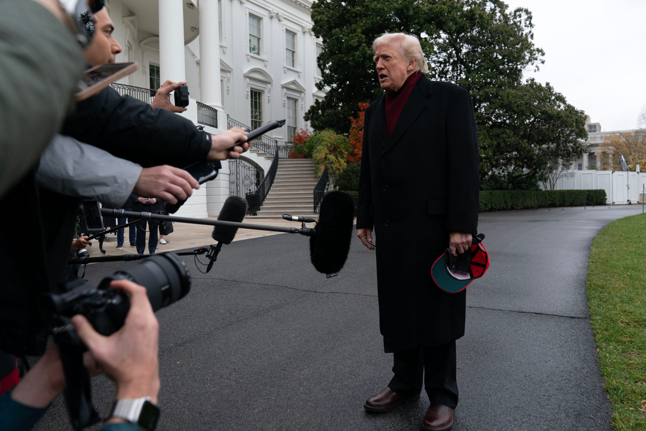 President Donald Trump talks to reporters as he departs from the South Lawn of the White House on Nov. 22, 2025, in Washington, D.C., en route to Joint Base Andrews.