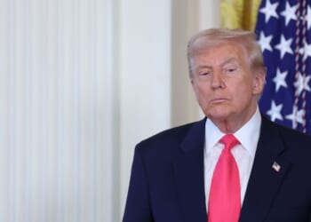 President Donald Trump listens as First Lady Melania Trump speaks at a signing ceremony for the "Fostering the Future" executive order in the East Room of the White House on Nov. 13, 2025, in Washington, D.C.