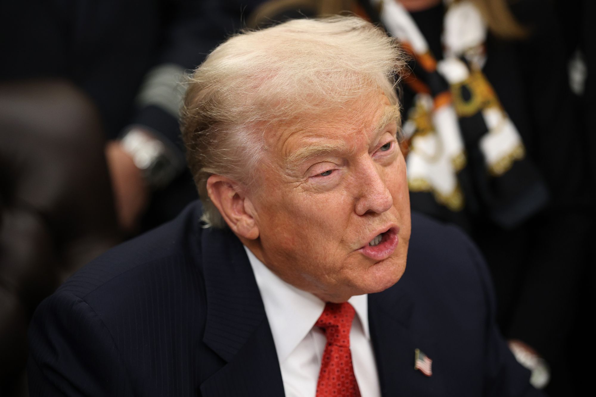 An image collage containing 1 images, Image 1 shows U.S. President Donald Trump speaking while wearing a suit and red tie