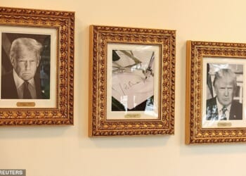 An image of an autopen signing former U.S. President Joe Biden's signature is displayed in place of a portrait Biden next to portraits of U.S President Donald Trump at the "Presidential Walk of Fame" along the Colonnade at the White House
