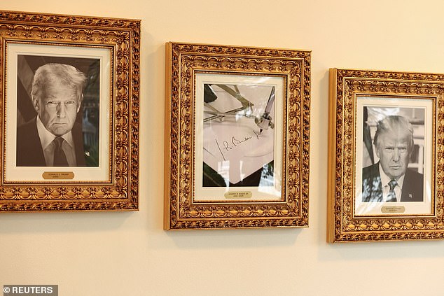 An image of an autopen signing former U.S. President Joe Biden's signature is displayed in place of a portrait Biden next to portraits of U.S President Donald Trump at the "Presidential Walk of Fame" along the Colonnade at the White House