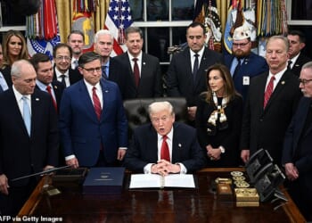 US President Donald Trump (C) speaks while signing the bill package to open the federal government in the Oval Office of the White House in Washington, DC, on November 12, 2025