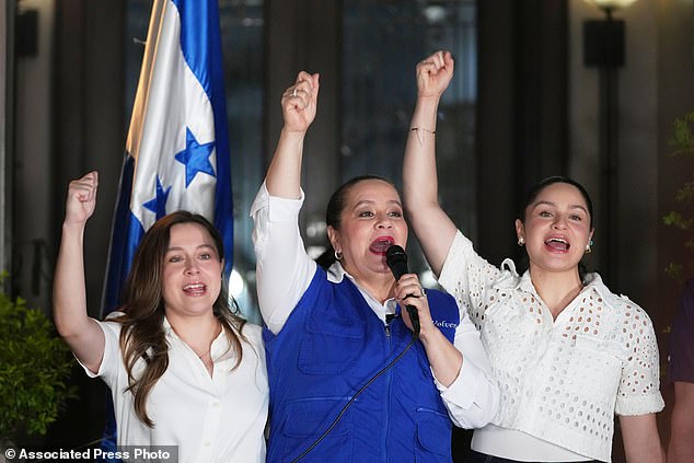 Ana García, center, wife of former Honduras' President Juan Orlando Hernández and his daughters Daniela, left, and Isabela raise their fists in Honduras, after Donald Trump said he would pardon Hernández, who is serving a 45-year prison sentence