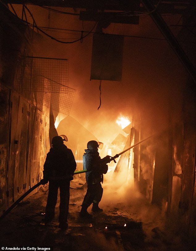 Firefighters work to extinguish the blaze after a Russian strike hit the central market in Kramatorsk, Donetsk region