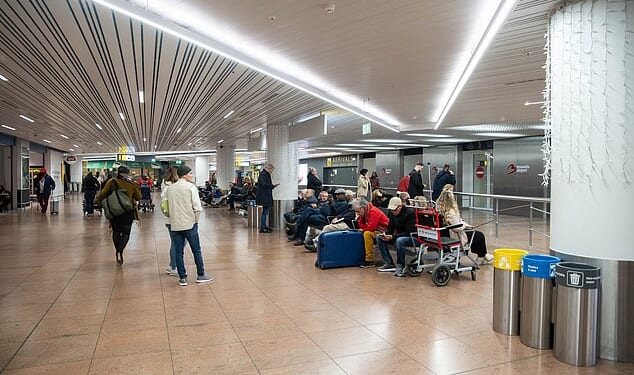 Brussels Airport is closed after the reported sighting of a drone, said the Belgian air traffic control service and a spokeswoman for the airport. Pictured: Travellers wait in an empty departure hall at Zaventem airport as air traffic is suspended following a reported drone sighting, in Zaventem outside Brussels, on November 4, 2025