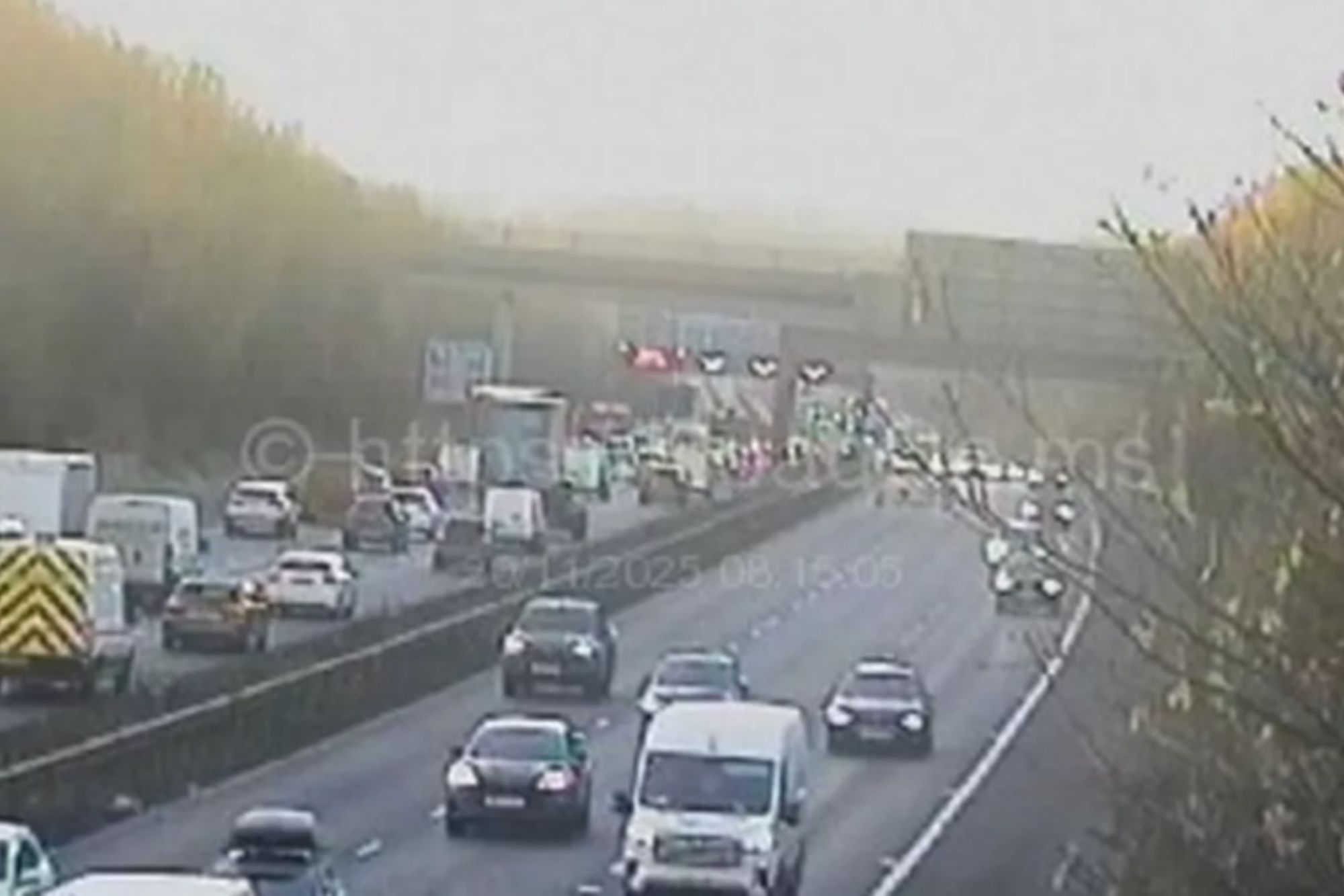 An image collage containing 1 images, Image 1 shows CCTV image showing heavy traffic on a multi-lane motorway with cars backed up due to an incident ahead