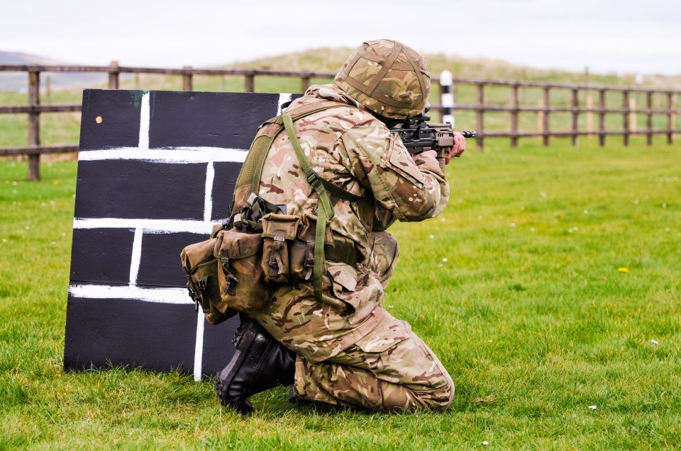 A soldier from the British Army trains on a military firing range with an assault rifle.