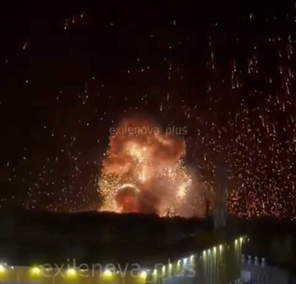 Nighttime explosion with sparks showering down.