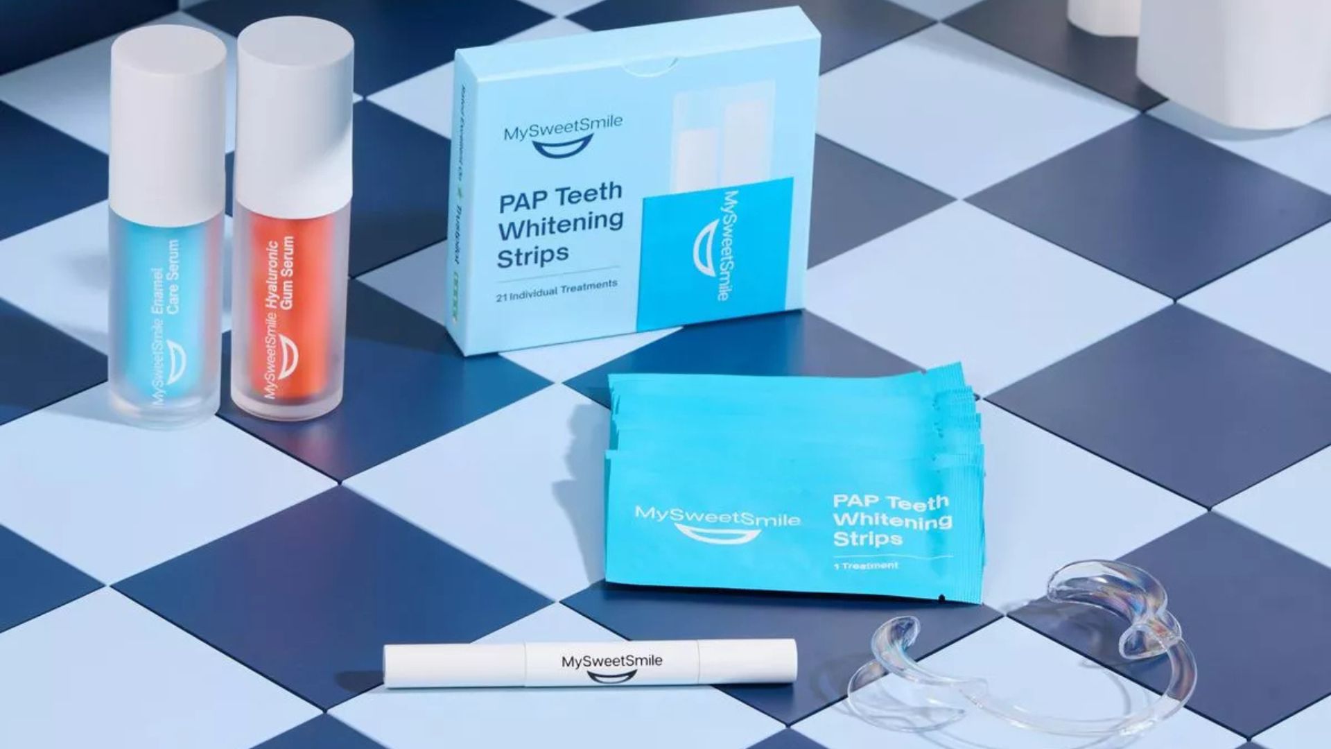 MySweetSmile oral care products, including enamel care serum, gum serum, whitening strips, and a teeth whitening pen.
