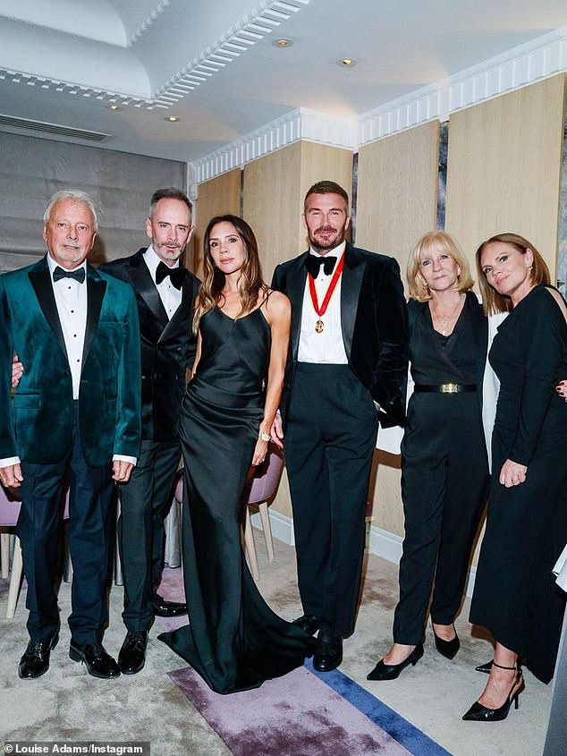 Victoria Beckham's rarely-seen brother Christian (second from left), has been pictured in a picture shared by his sister Louise as the family celebrated brother-in-law David's knighthood