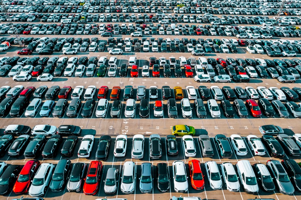 Aerial view of a large number of cars parked in rows.