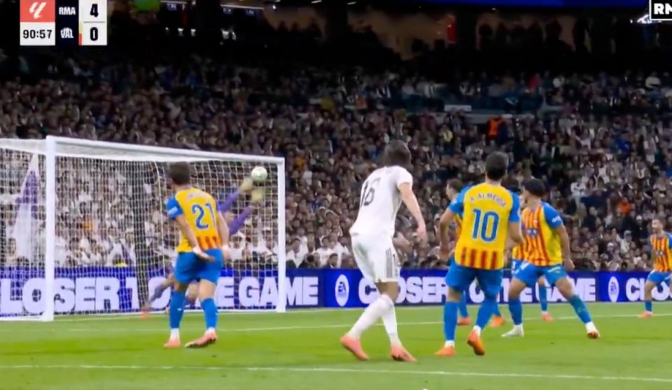 Soccer players with one player shooting a goal while the score in the top left shows RMA 4, VAL 0 at 90:57.