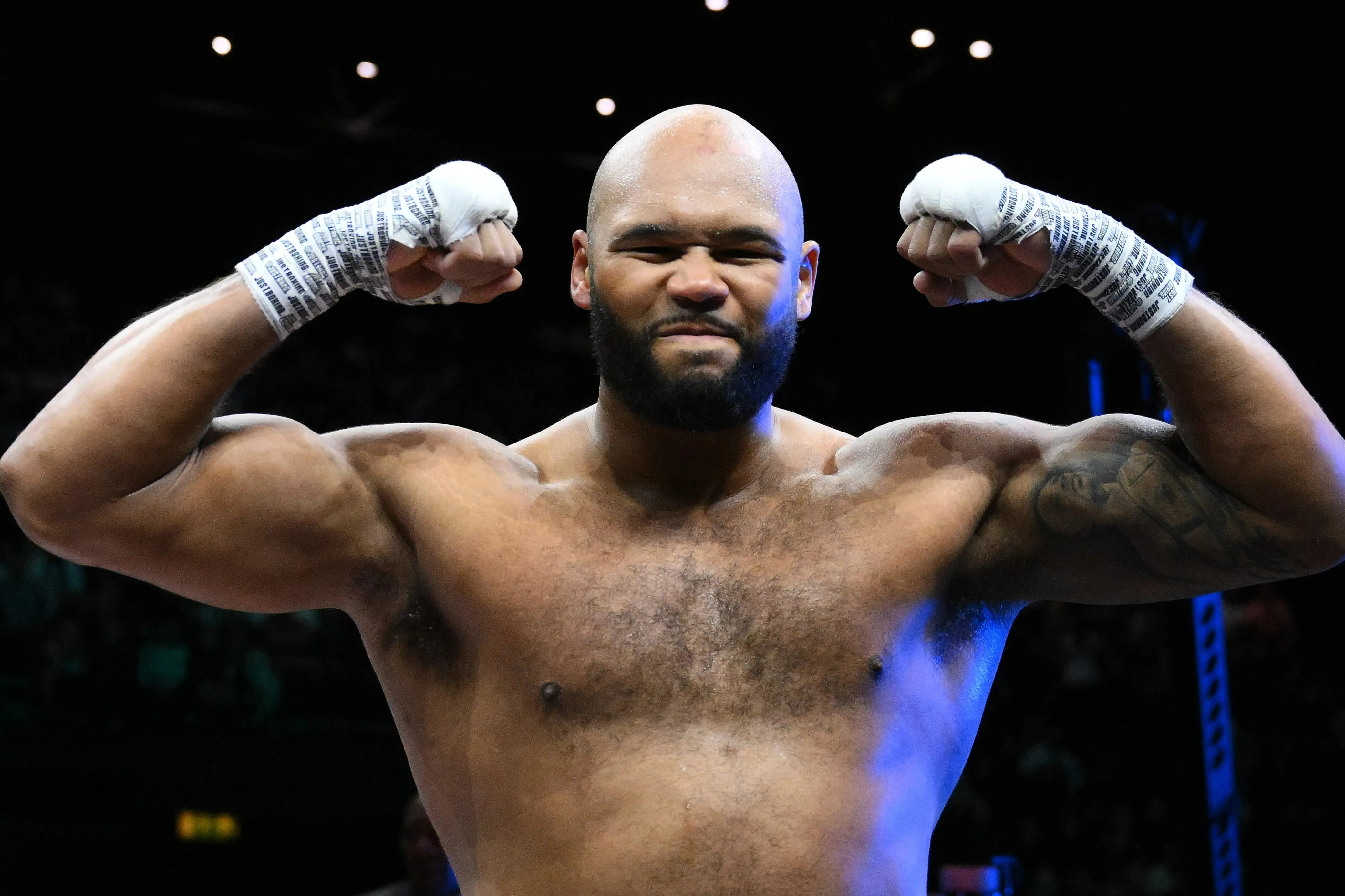 Frazer Clarke flexing his muscles after a boxing match.
