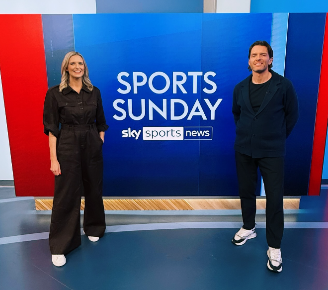 Two presenters stand in front of a blue screen with "Sports Sunday Sky Sports News" written on it.