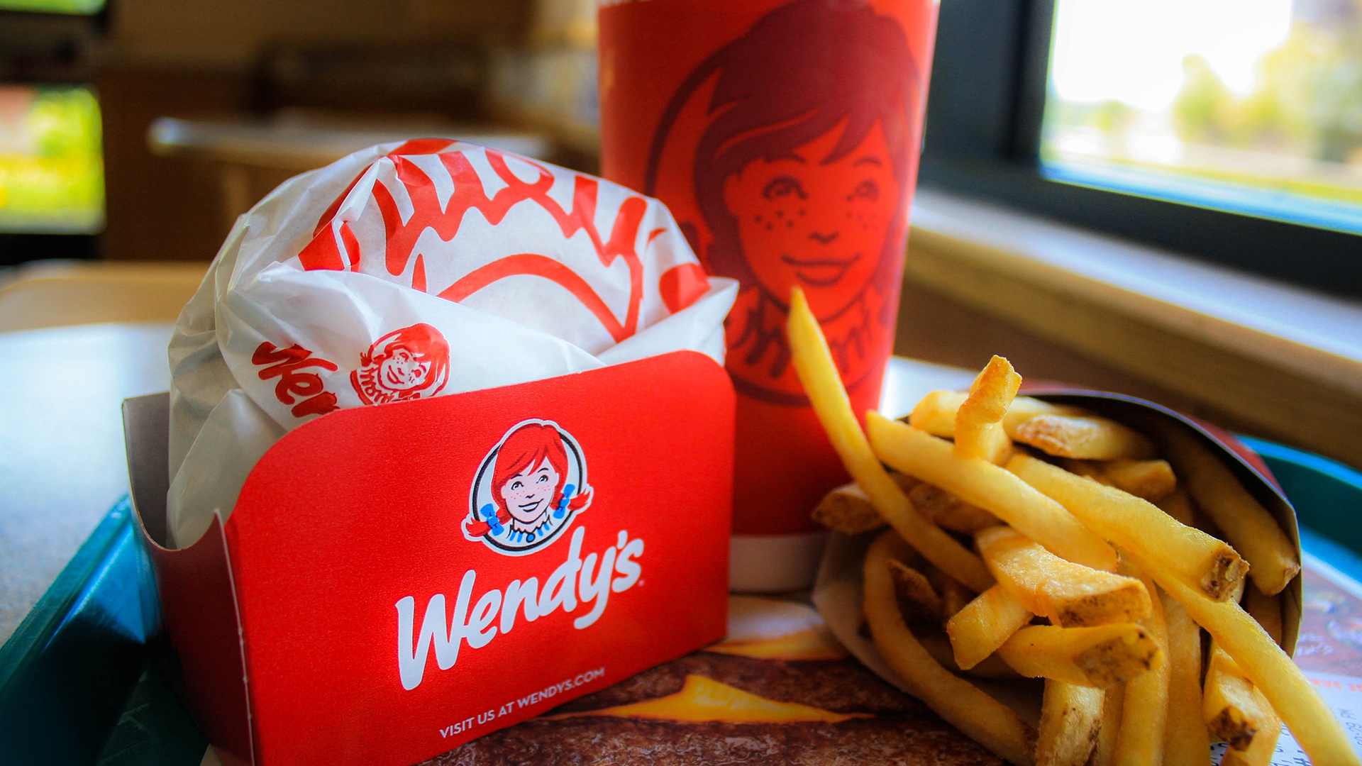 A Wendy's meal with a burger, fries, and a drink.