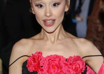 Ariana Grande showed off her 40 hand 'prison' tattoos as she stepped out for the premiere of Wicked: For Good in Paris