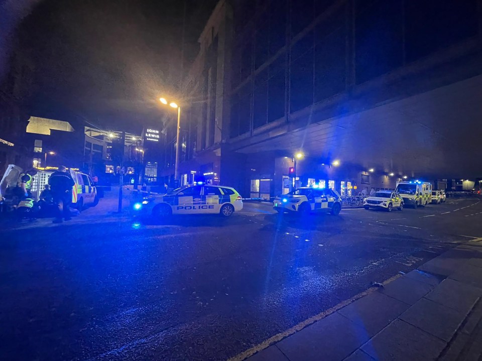 Nighttime photo of several police cars with flashing blue lights at an incident on Buchanan Street in Glasgow.