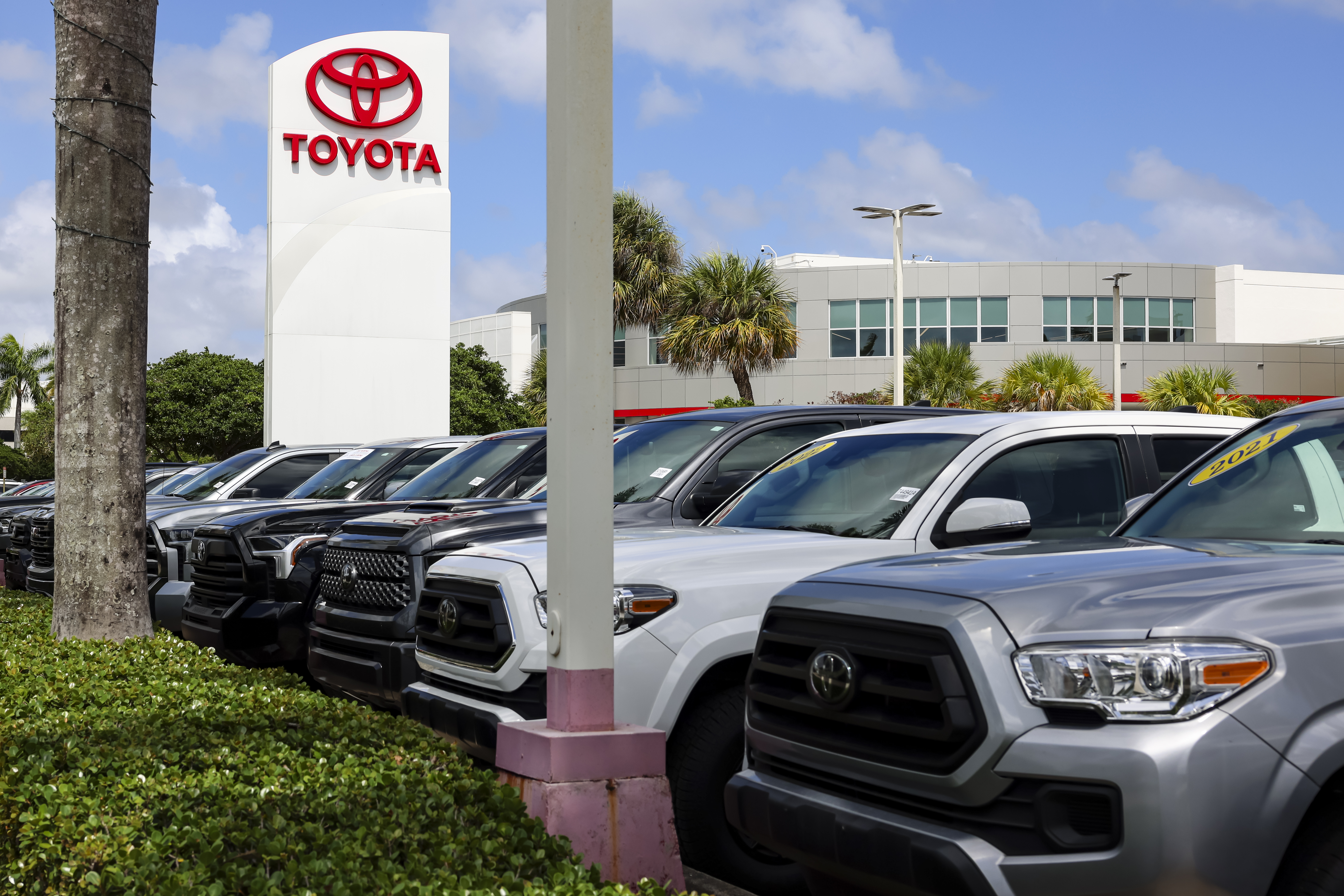 Used vehicles displayed for sale at a Toyota dealership in Miami, Florida.