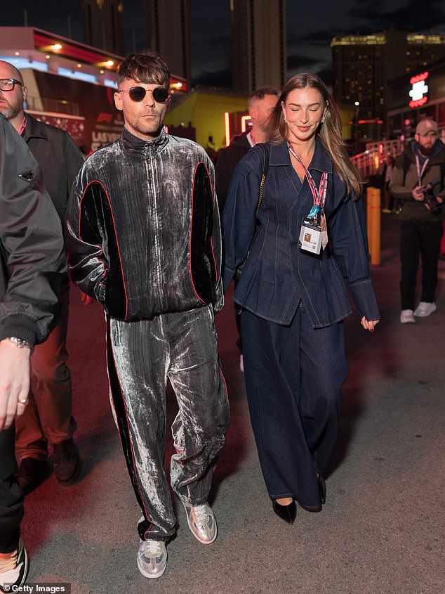 The Love Island star, 28, was seen smiling and walking hand-in-hand with the singer, 33, in the paddock on Saturday, with the One Direction star catching the eye in a distinctive velour tracksuit (seen)
