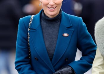 Zara Tindall wrapped up warmly in a striking blue coat as she braved the winter chill at Cheltenham Racecourse today