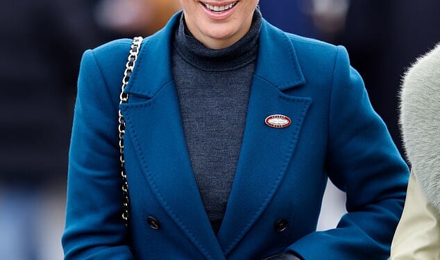 Zara Tindall wrapped up warmly in a striking blue coat as she braved the winter chill at Cheltenham Racecourse today
