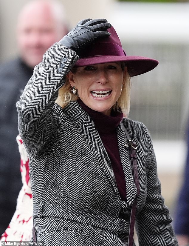 Yesterday Zara was forced to hold onto her hat today as she braved blustery and wet conditions at Cheltenham