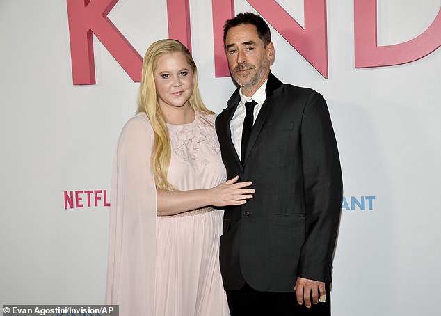 Noticeably missing was Schumer's elusive husband of seven years, Chris Fischer (R, pictured February 3) who, like her, doesn't always wearing his wedding band