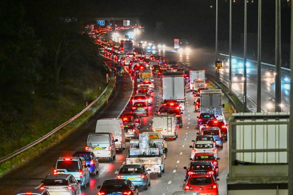 Night-time view of traffic almost at a standstill on the M5 motorway in Exeter.