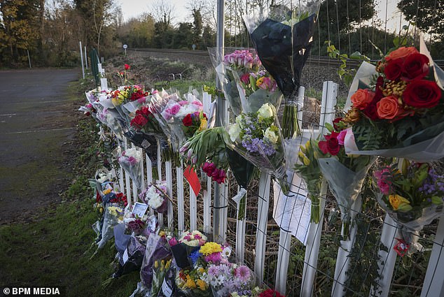Floral tributes pictured at a railway crossing off Chestnut Grove in Burton Joyce, Nottinghamshire, following the death of Josh Travis, aged 14.