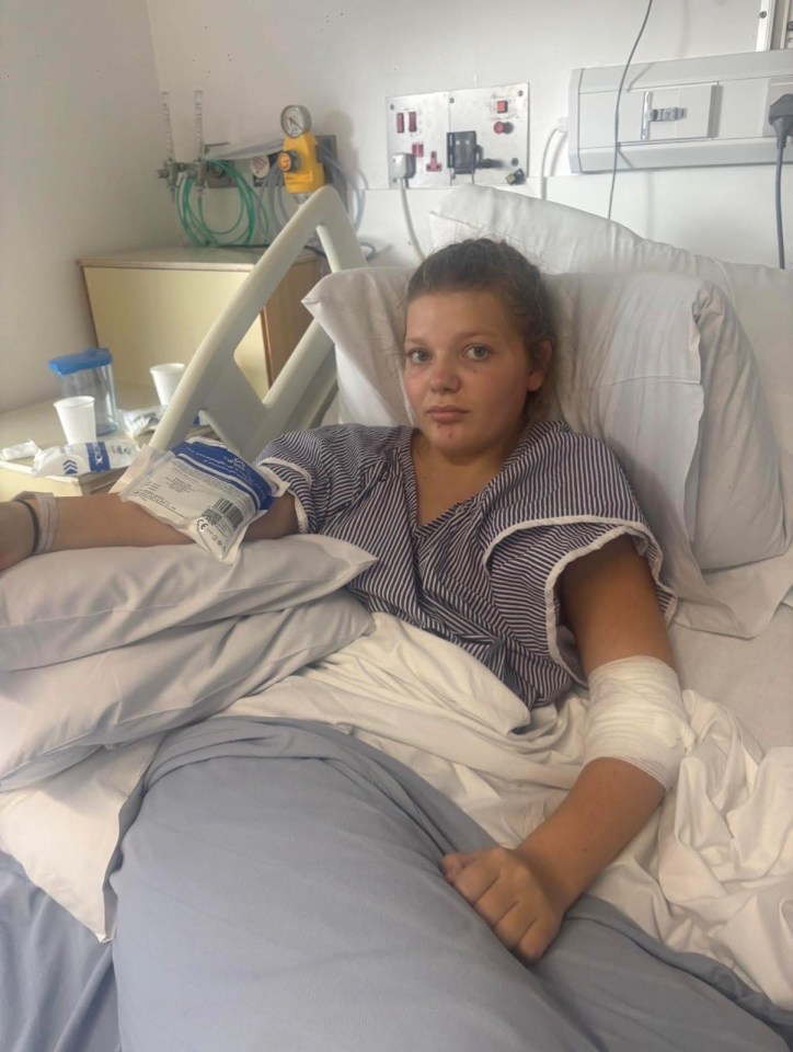 Millie Fairley, 13, in a hospital bed with a bandage on her arm.