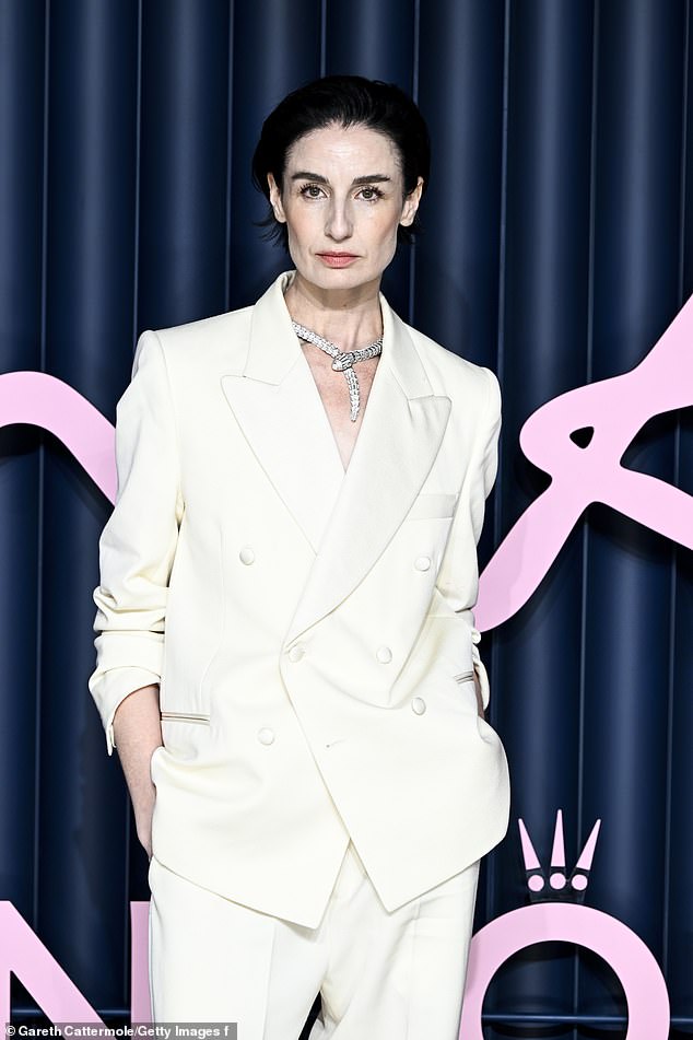 The model wore a snake necklace and slicked her hair back