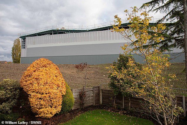 The view from one resident's backyard showing the 18-metre giant grey warehouse