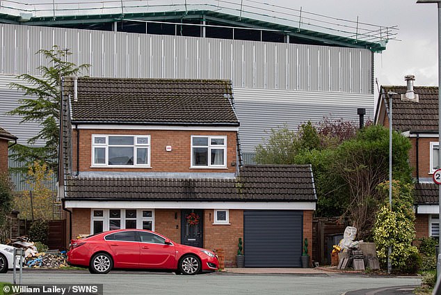One of the 18-metre-high warehouses towering over a two-storey home in Tyldesley