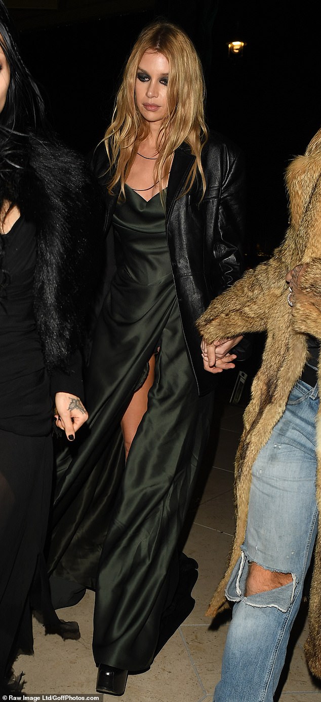 Model Stella Maxwel stunned in a black satin gown and dramatic eye make-up