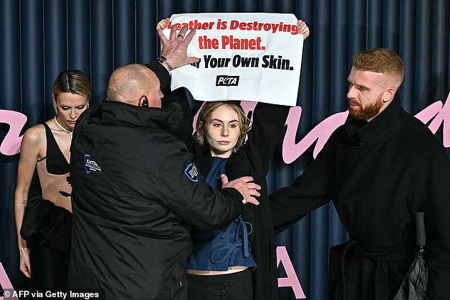 The animal rights activists stood beside actress Wallis Day while she posed for photos ahead of the ceremony