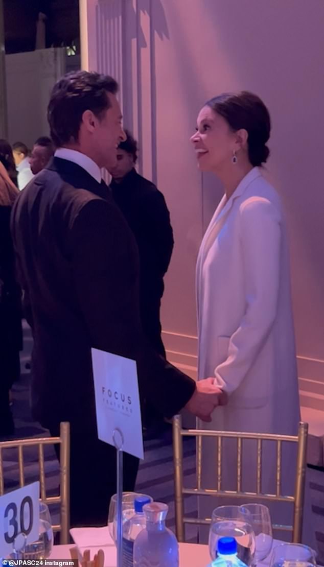 Jackman held onto Foster's hand during their animated chat