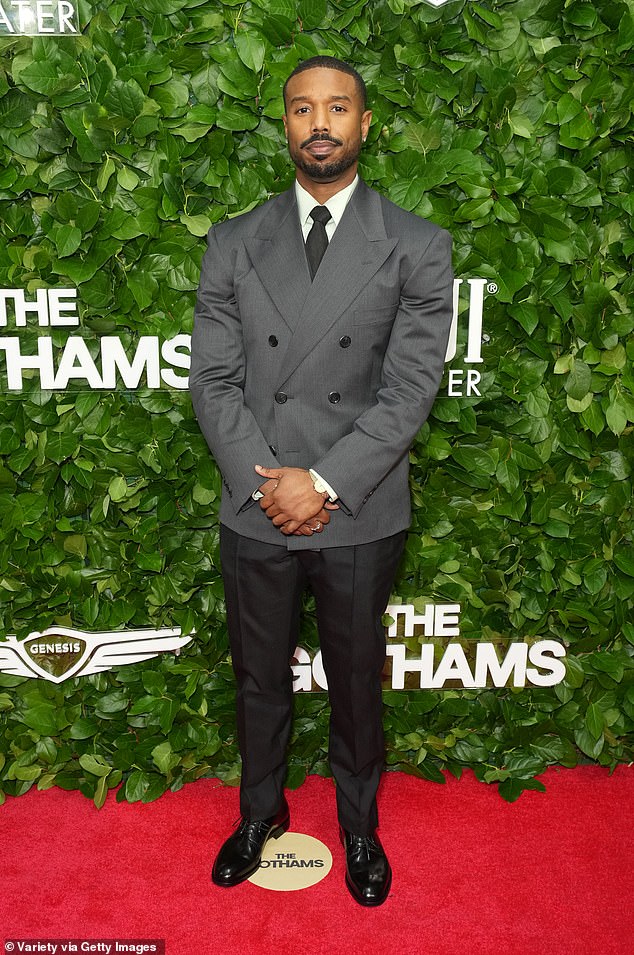 Michael B. Jordan, 38, smoldered for shutterbugs while rocking a chic gray blazer, white dress shirt and black tie