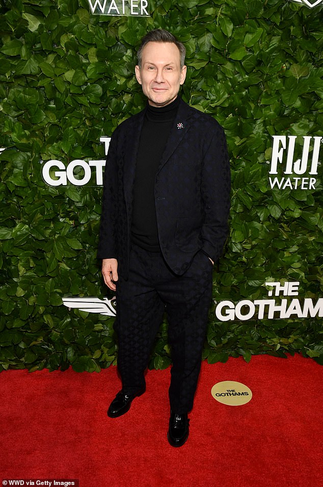 Christian Slater, 56, cut a stylish figure in a patterned black and navy blue blazer, a black turtleneck and baggy trousers