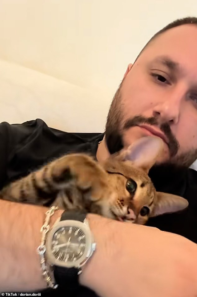 Albanian burglar Dorian Puka, 29, who is living in the UK despite being deported twice, is seen here posing with his £45,000 Patek Philippe Aquanaut