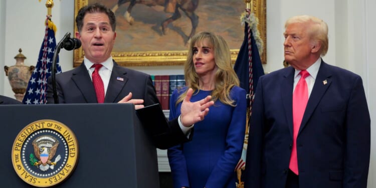 Tech billionaire Michael Dell speaks as his wife Susan Dell and President Donald Trump look on while making an announcement about "Trump accounts" in the Roosevelt Room at the White House on Dec. 2, 2025, in Washington, D.C.