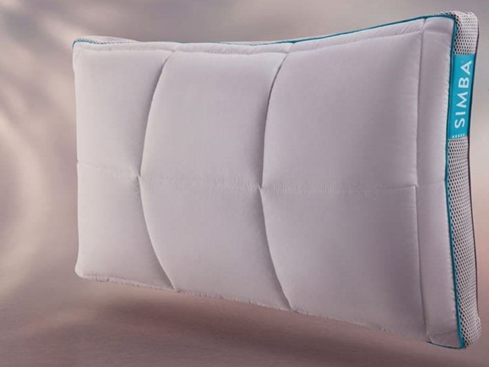 White Simba pillow with teal trim and Simba logo.