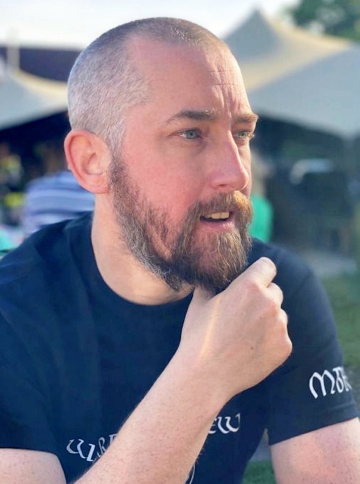 PC Mathew Parker, a bearded man, looks away from the camera.