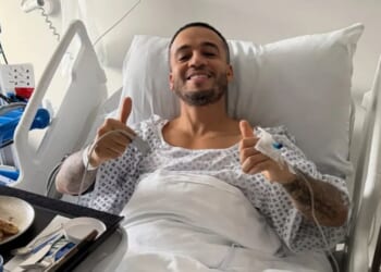 JLS star gives fans health update as he shares photo from hospital bed after operation