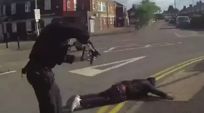 Dramatic moment armed cops swoop on 'cowardly' killer, 39, who stabbed three people as he lies face down in road