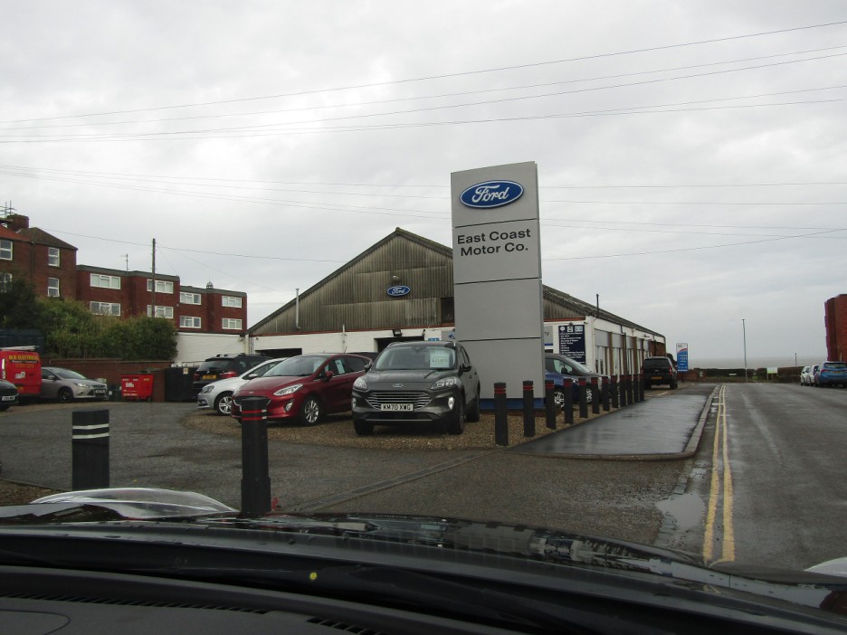 East Coast Motor Co. dealership with new Ford cars in the lot.