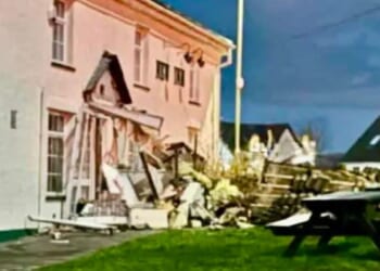 Bulldozer driver flattens car and 'deliberately' smashes into village pub in 'targeted' attack