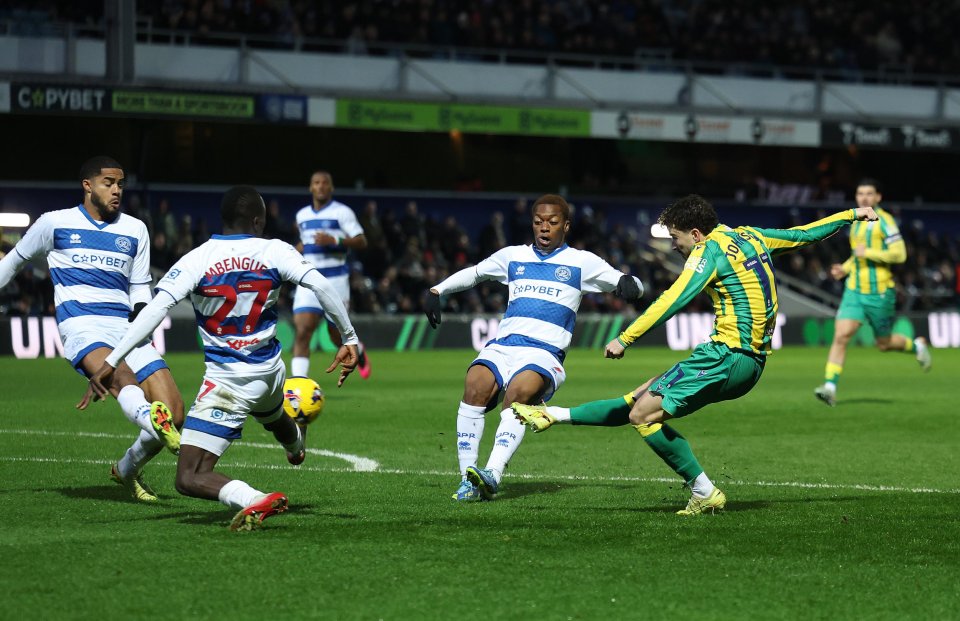 West Bromwich Albion player #17, Daryl Dike, kicking the ball past a Queens Park Rangers player.