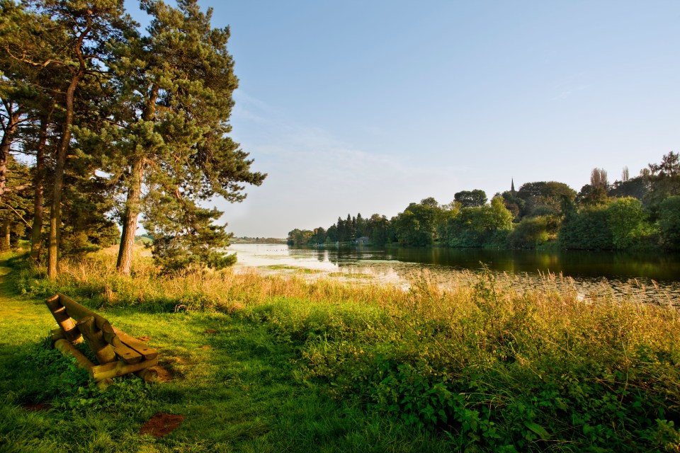 View across Thornton Reservoir with a church in the distance.